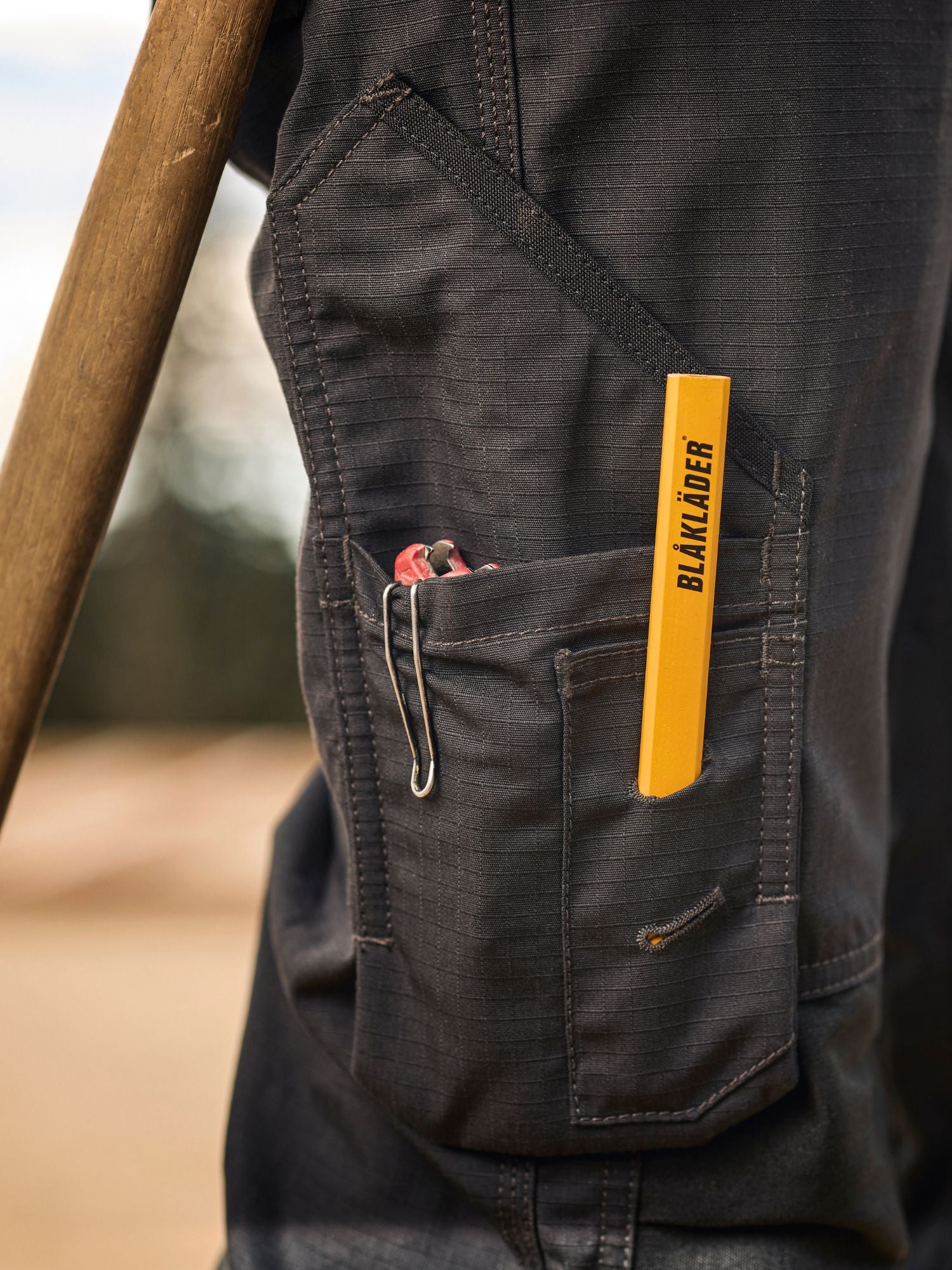 Blaklader Ripstop Pants in black cargo utility pocket layout with tools in it