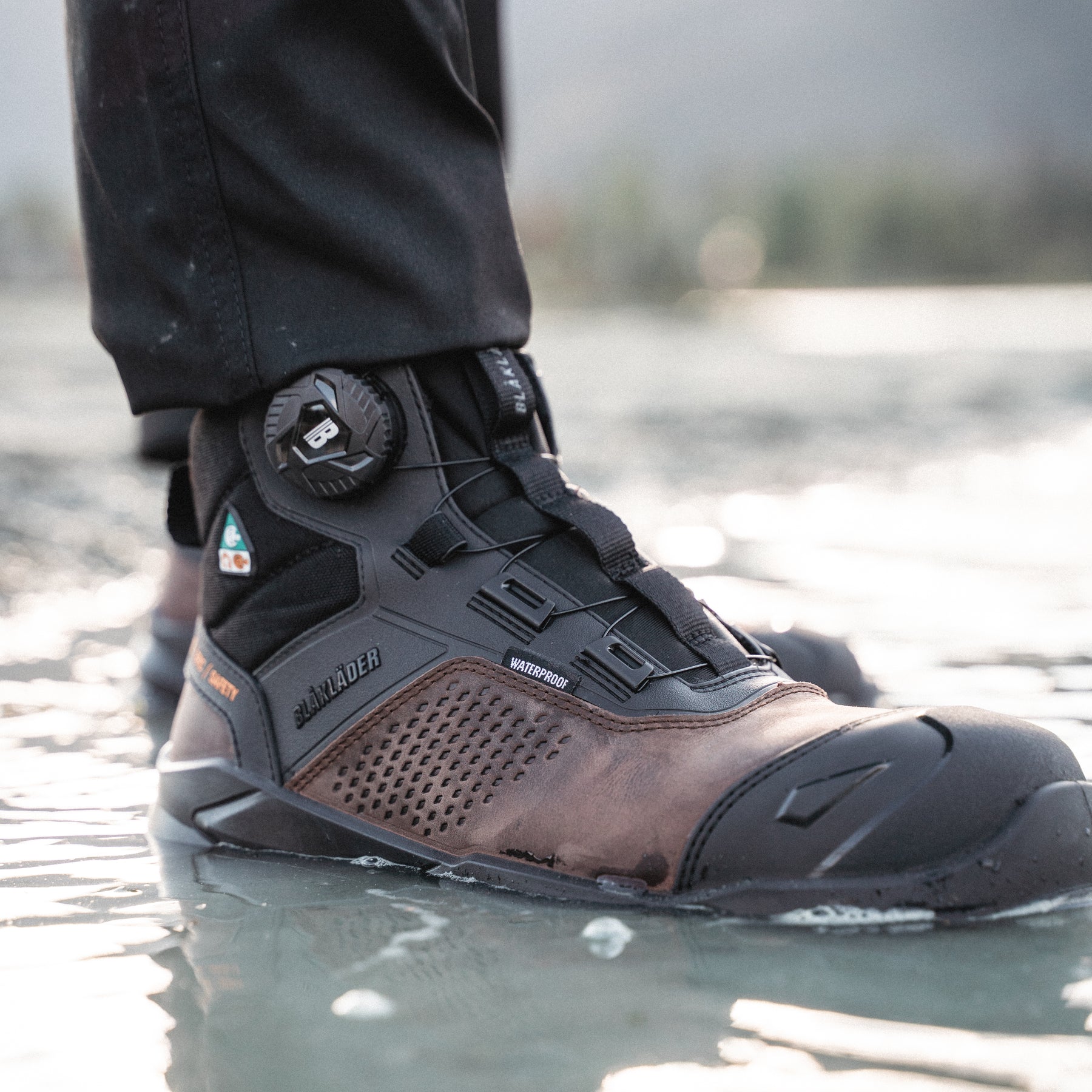 Tradesman wearing the Epic Freelock Safety Boot in Brown/Black
