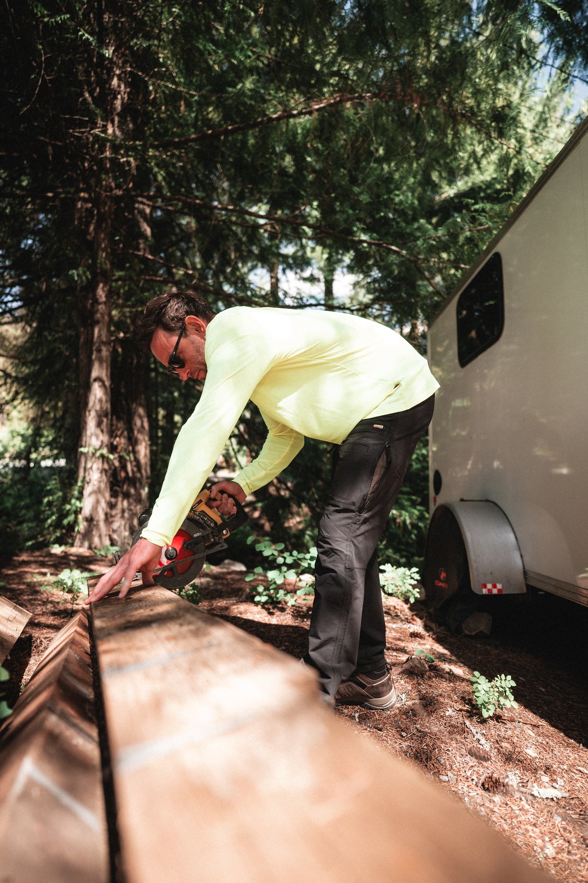 Tradesman wearing Solano Ventilated Lite pants in black and Performance Sun Hoodie in Yellow